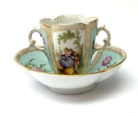 A Helena Wolfsohn Dresden porcelain quatrefoil twin handled chocolate cup and stand, painted with panels of courting figures 