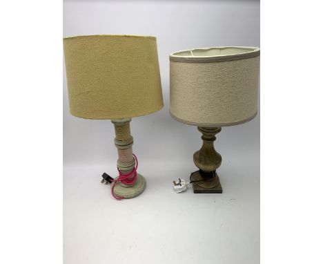 A turned wooden lamp base, with cream shade, overall H53cm, together with another wooden lamp base, the column modelled as th