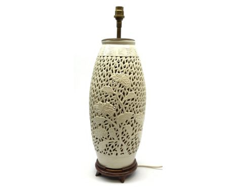 A Chinese reticulated or pierced white glazed lamp base, on wooden stand, overall H52.5cm.  - Condition Report 