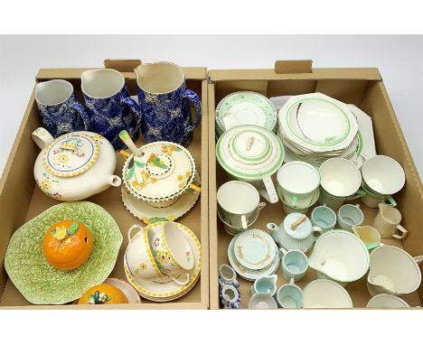 A Susie Cooper for Grays Pottery teapot, two tea cups, and four saucers, painted with flowers within a yellow dot border, pat