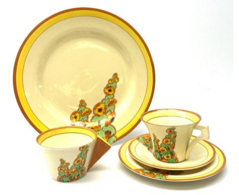 A Clarice Cliff Bizarre by Wilkinson Limited dinner plate, trio and cup in the Sunshine pattern. (5). - Condition Report 