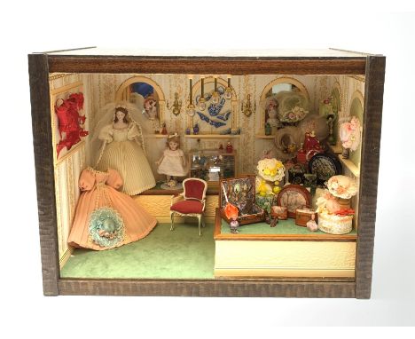 A 1/12th scale diorama of a ladies boutique, depicting a wall papered and mirrored interior with Hepplewhite style chair, man