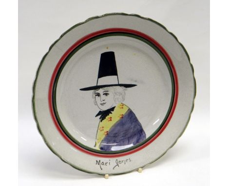 A LLANELLY ‘MARI JONES’ PLATE of circular form with green and red trim, painted with head and shoulders portrait of Mari Jone