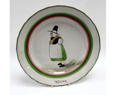 A LLANELLY PLATE SIGNED BY SHUFFLEBOTHAM of circular form with green and red trim, painted with a portrait of a standing lady