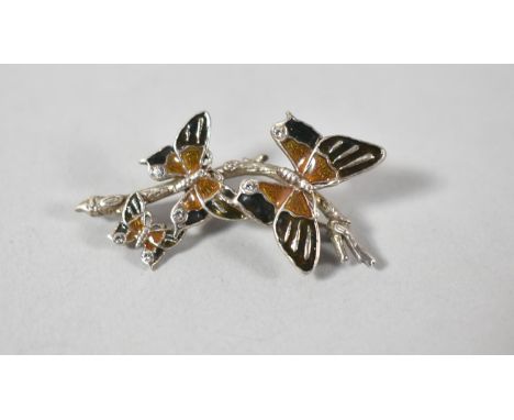 A Silver, Enamel and Jewelled Brooch in the Form of Three Graduated Butterflies 