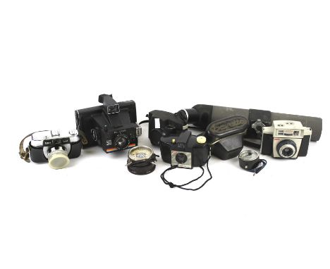 A group of six assorted vintage film cameras. Including Kodak, Polaroid, plus a spotting scope