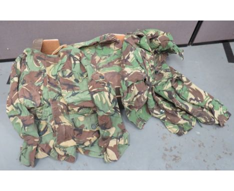 Six British Army Combat Smocksbrown, tan, black and green camouflaged smocks with hoods.  Patch pockets with buttoned flaps. 