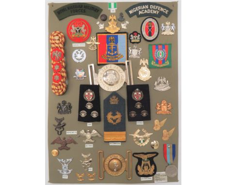 38 Items Of Insignia For Nigerian Forcesdisplay board with good tabulated display of metal and cloth badges including white m