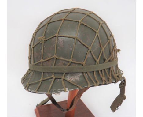 American Post Nov 1943 Front Seam MI Helmet dark green shell. &nbsp;The edge brim with front seam. &nbsp;Hinged chinstrap loo