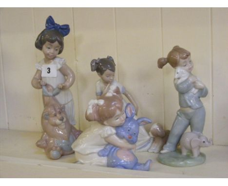 Four Nao figures of girls with toys and animals in various poses.