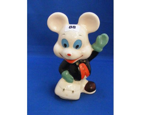 A Mickey Mouse ceramic money box depicting Mickey with hand painted black jacket and red waistcoat, green gloves and blue eye