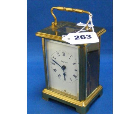 A French brass carriage clock, the white enamel face marked Bayard.