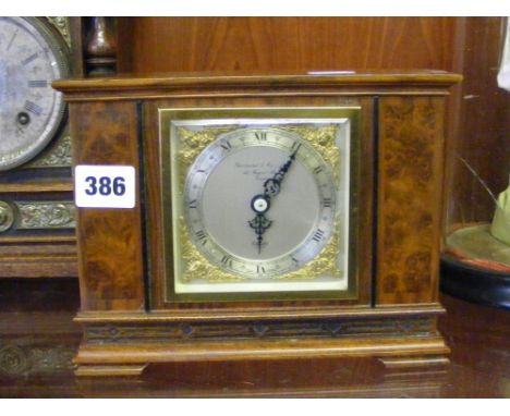 A circa 1920's Elliot walnut mantel clock for Garrard & Co of Regent St. with blind fret decoration.
