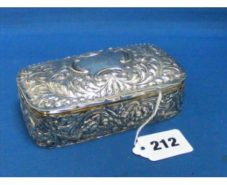 A nice silver box with gilded interior and heavily embossed decoration of flowers and leaves, 12 x 7cms, H/M Birmingham 1906.