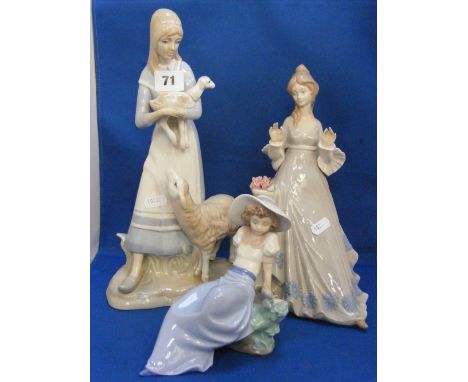 A Nao figure of a recumbent girl with a bird at her side, plus two Lladro style figures of ladies.