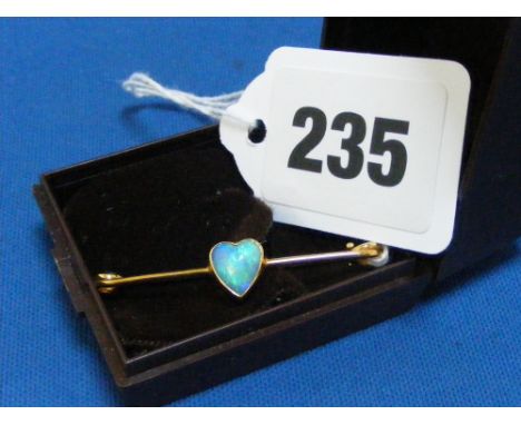 A 9ct gold bar brooch set with a heart shaped opal.