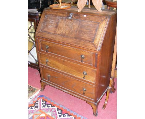 An oak bureau, fitted three drawers on bracket supports, with internal fitments.