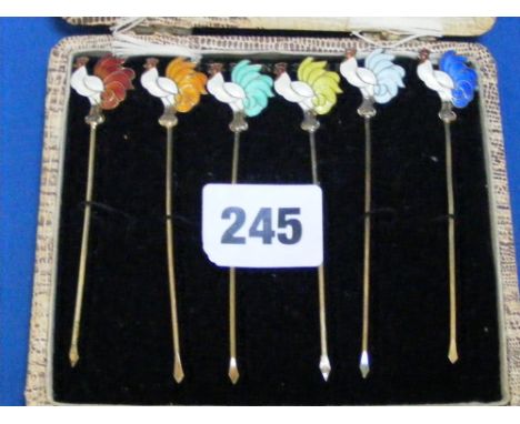 A boxed set of Norwegian sterling silver cocktail sticks with enamel cockerels to the top.
