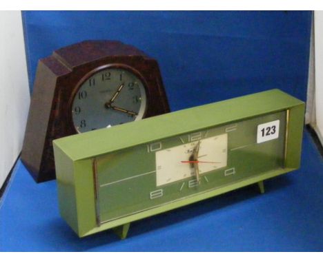 A stylish green Bakelite clock on metal having splayed legs and of innovative design and a brown Bakelite Ingersoll clock of 