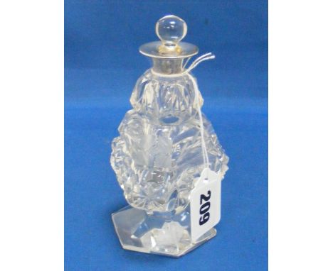 An unusual Art Deco cut glass scent bottle with silver collar and glass stopper.