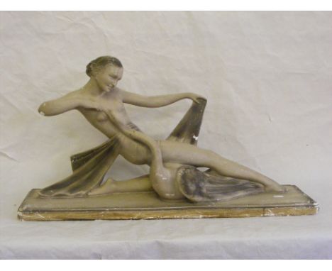 A plaster Art Deco figure of a reclining lady entwined around a swan, marked Depose S. Melani to base.
