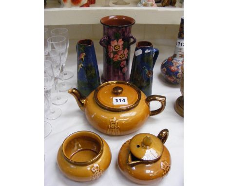 A Longpark tri-handled vase decorated with flowers, together with two other Longpark jugs decorated with birds, plus a three 