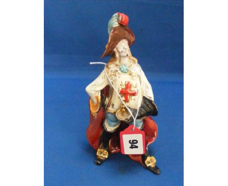 An old Italian ceramic figure in the form of a colourfully attired musketeer.   