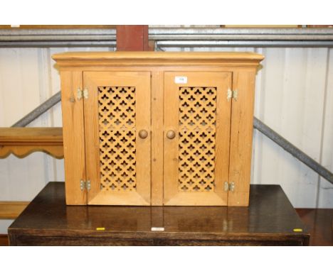 A pine two door cupboard; a pine dresser rack and a pine wall shelf