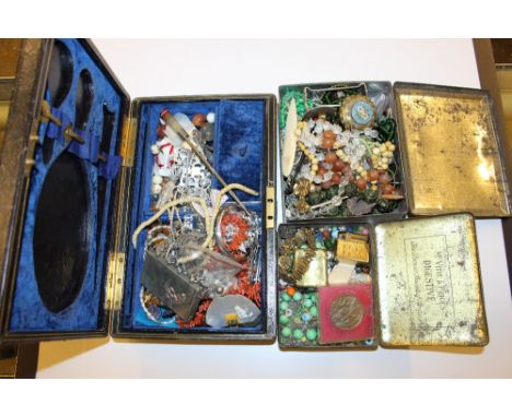 Two tins and a black leather jewellery box of costume jewellery; lighter; a Jubilee crown etc.