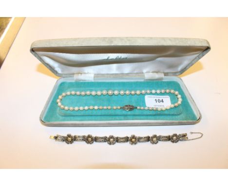 A pearl necklace with 9ct white gold clasp and matching bracelet