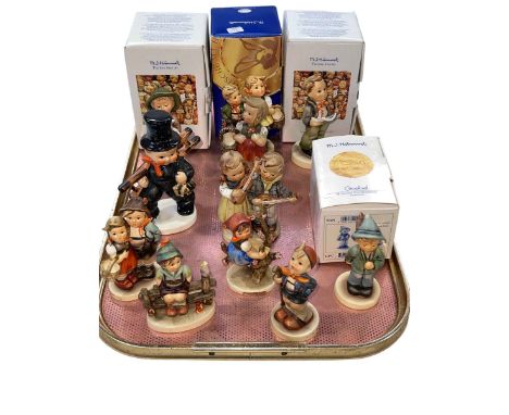 Collection of eleven Hummel figures, some with boxes.