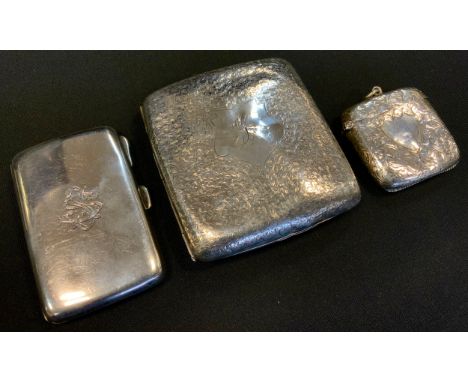 An Edwardian silver cigarette case, Birmingham 1904; another smaller plain,  Birmingham 1919;  vesta case, 1906, 198.2g gross