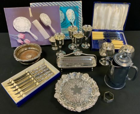 A plated bottle coaster, draught turned base, c.1880;  Sheffield plated card waiter;  goblets;   knives, dressing table sets;