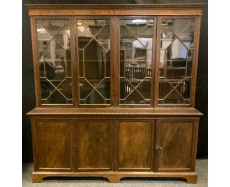 A Victorian mahogany bookcase cabinet, two pairs of astral glazed doors to top enclosing three tiers of shelving, the base wi