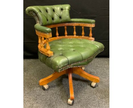 A 20th century swivel office chair, green button back 