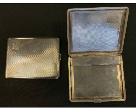 A George V silver cigarette case, engine turned covers, Chester 1928; another Birmingham 1928, 310g gross (2) 
