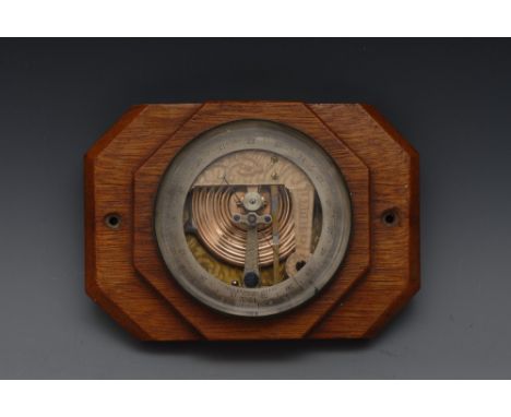 A John Browning Patent No.51 marine aneroid barometer, 9cm silvered register, oak Art Deco mount, 16.5cm wide overall