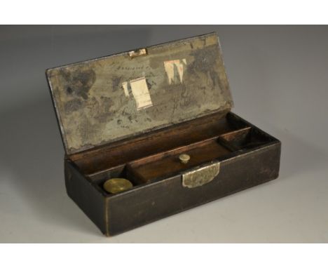 A George III leather covered rectangular travelling scribe's box, hinged cover enclosing an inkwell and an arrangement of com