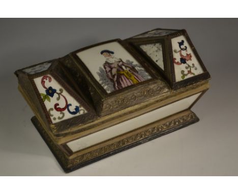 A 19th century French reverse painted glass, card and gilt metal shallow sarcophagus vanity box, architectural cover centred 