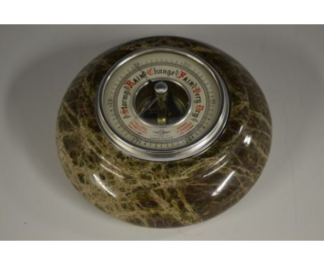 A Cornish serpentine aneroid barometer, 7.5cm register, turned border, 14.5cm diam overall 