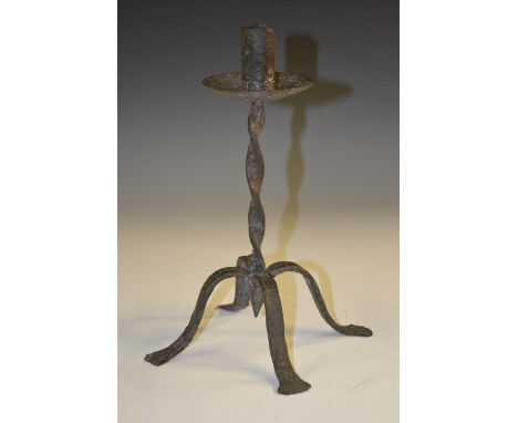An 18th century wrought iron candlestick, sleeve sconce, twisted column, pad feet, 26cm high
