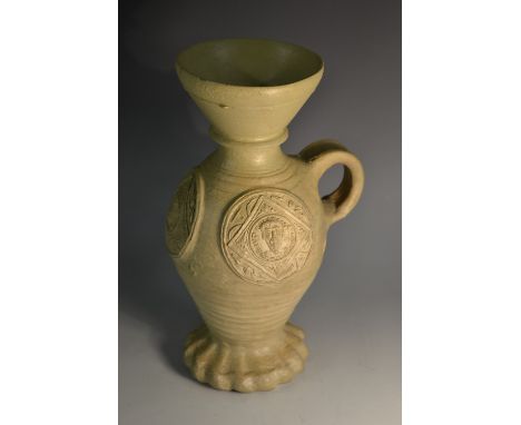 A 16th/17th Siegberg stoneware funnel-necked wine jug, glazed in sallow tones, applied with Renaissance portrait roundels of 