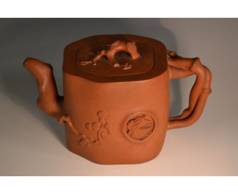 A Chinese Yixing terracotta tea pot, moulded and applied with prunus root finial and bamboo handle, 19.5cm high, seal mark  