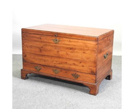 An 18th century yew wood chest, with a hinged lid and containing a single drawer below, flanked by carrying handles, on brack