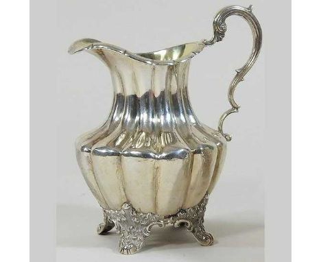 A Victorian cream jug, on scrolled feet, London 1842, 210g14cm highCondition report: Solid and hallmarks are clear. Some ligh