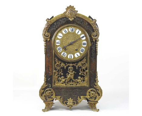 A 19th century French cut brass and tortoiseshell mantel clock, in the manner of Boulle, with scrolled brass mounts and decor