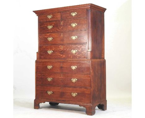 A George III oak chest on chest, the upper section containing two short over three long drawers, between reeded pilasters, wi