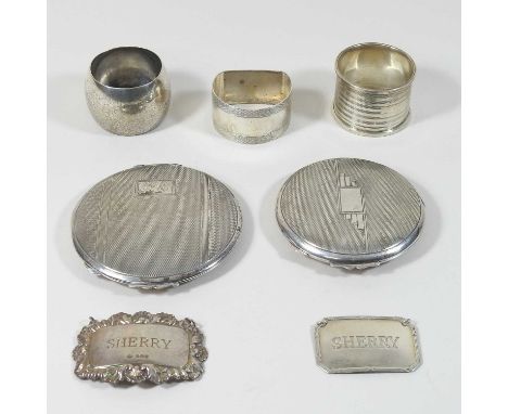 A silver compact, of hinged circular shape, Birmingham 1947, 8cm diameter, together with another, three various napkin rings 