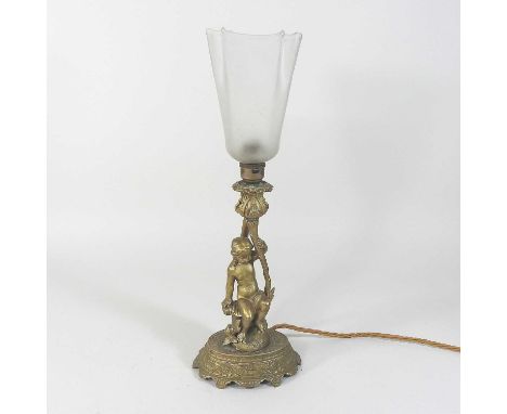 An early 20th century bronzed figural table lamp, with an opaque glass shade, cherub support and oval base43cm high overall