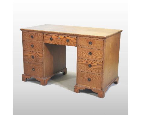 A Victorian light ash pedestal desk, containing nine short drawers, on bracket feet120w x 60d x 75h cm